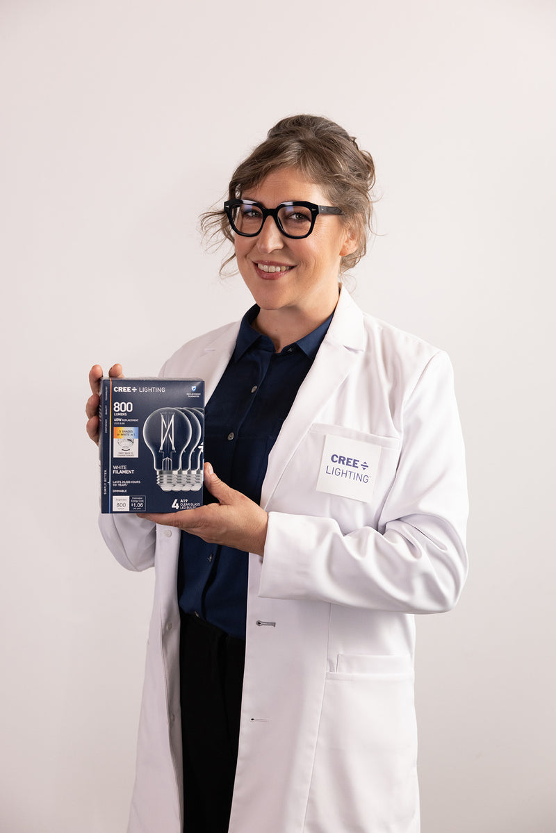 Mayim Bialik in cree lighting lab holding a package of Cree lighting products 