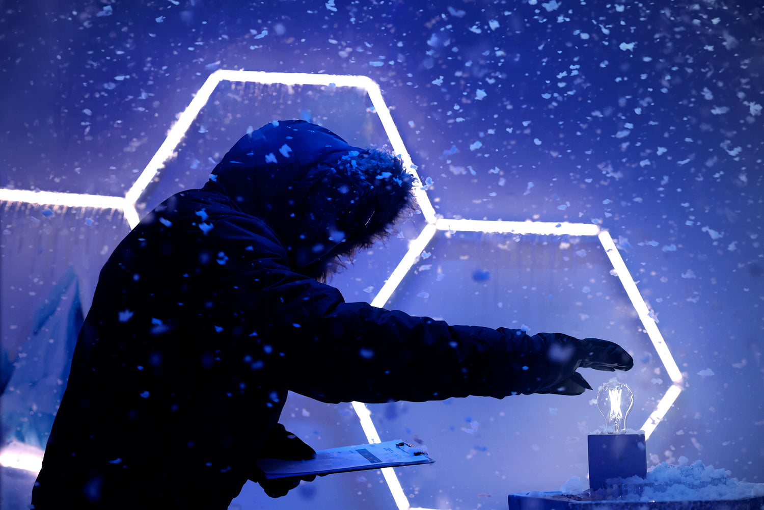 cree lighting lab technician  in dark clothing holding a tool near a small light source against a blue geometric background